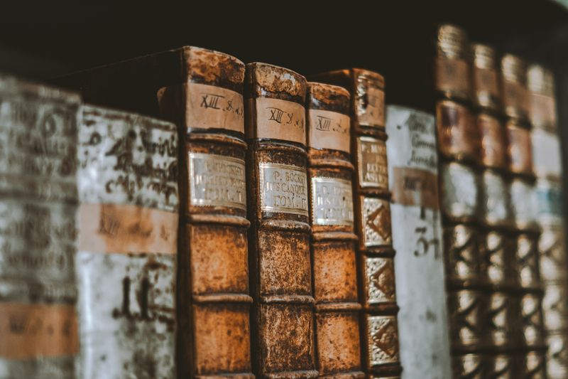 Vintage leather-bound books in a dimly lit library